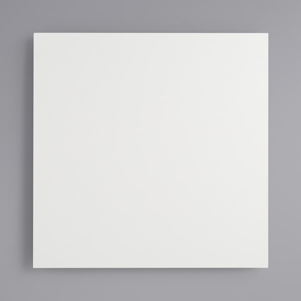 A white square Melamine-coated wood cake board with feet.