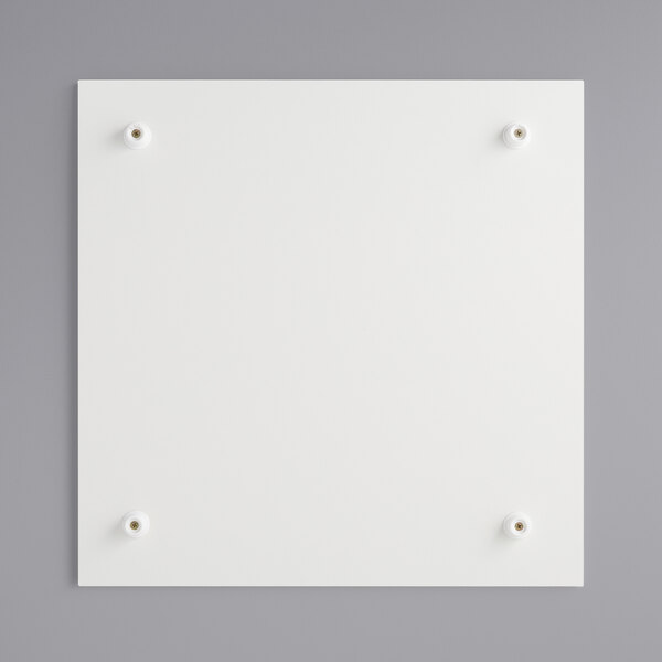 A white square melamine-coated wood cake board with metal feet.