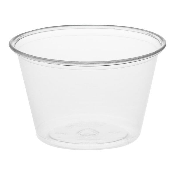A clear plastic Dart souffle cup with a rim.