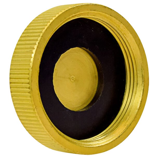 A Vectorfog brass fuel tank cap with black center and yellow lettering.