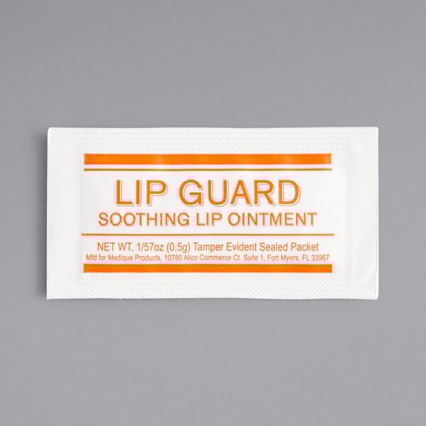 A white and orange Medique Lip Guard packet with red text.