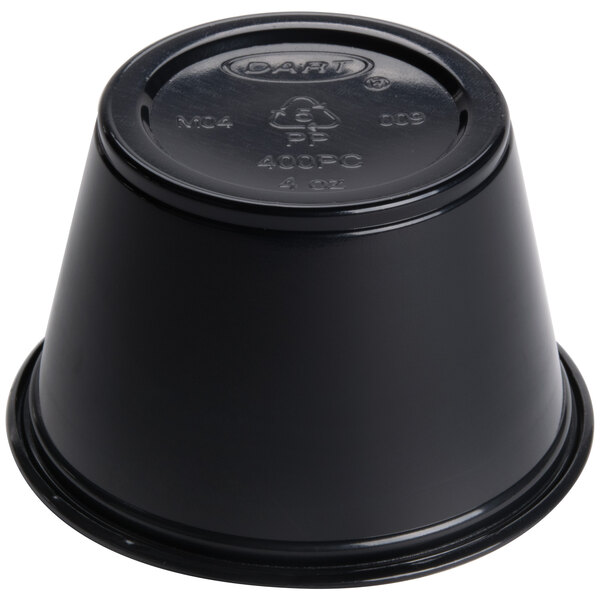 A black Dart plastic souffle container with a lid.