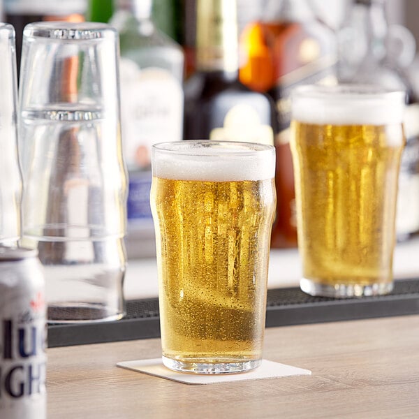 A couple of Pasabahce nonic beer glasses on a table