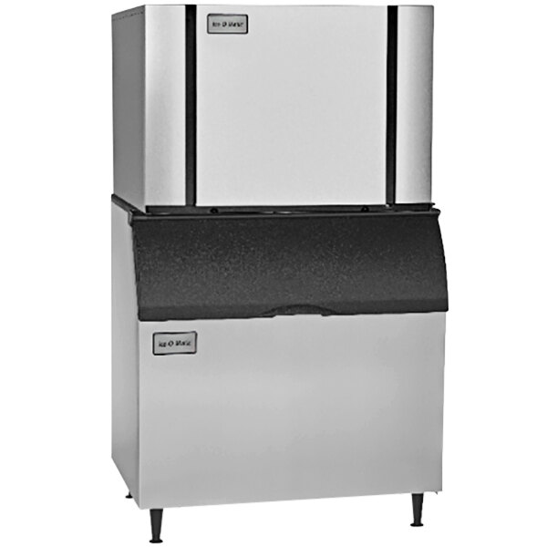 A silver and black Ice-O-Matic air cooled ice machine with two doors.