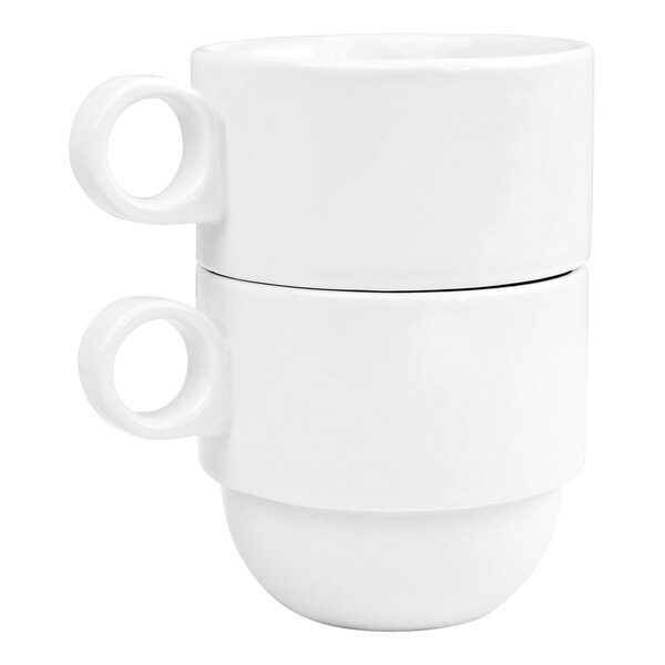 A pair of stackable bright white porcelain mugs with circular handles.