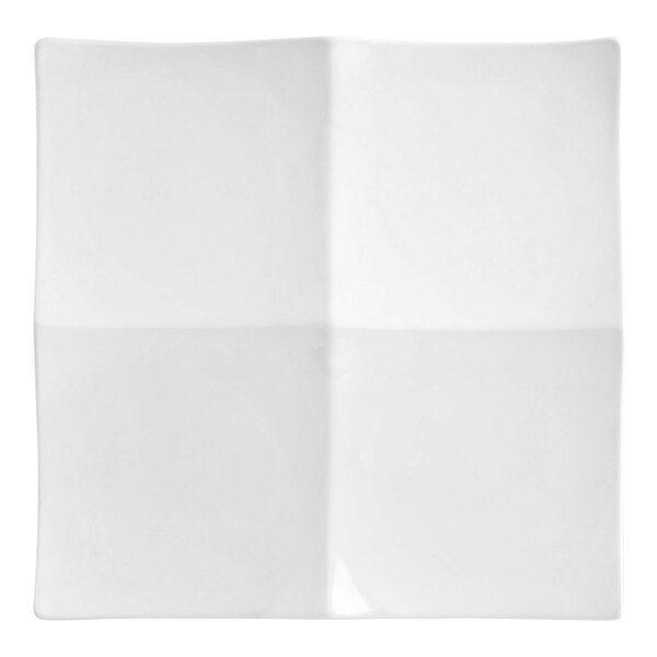 A white square porcelain plate with four separate compartments.