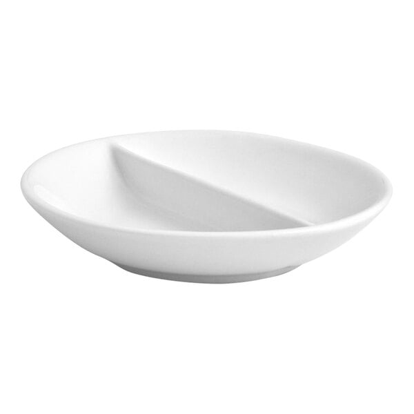 A round, bright white porcelain dish with a divider in the center, designed for serving small portions or condiments.