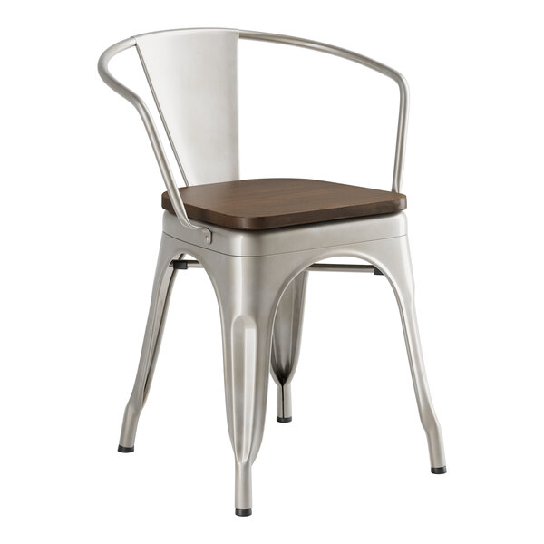A Lancaster Table & Seating metal arm chair with a wooden seat.