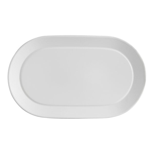 A white oval porcelain platter with embossed lines and a wide rim.