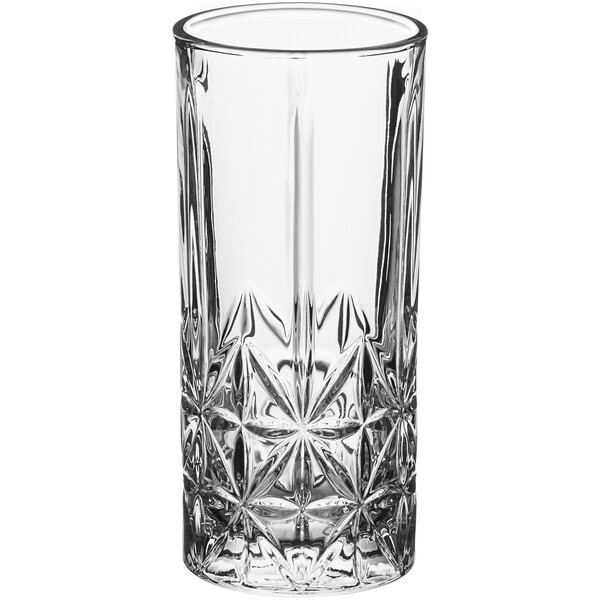 A close-up of an Acopa Gardenia highball glass with a star pattern.