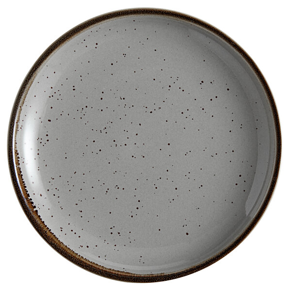 An Acopa Keystone granite gray stoneware coupe plate with speckles.