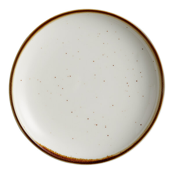 A white Acopa stoneware coupe plate with brown specks.