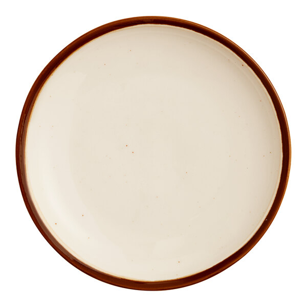 A round stoneware coupe plate with a vanilla bean-colored surface and a brown rim.