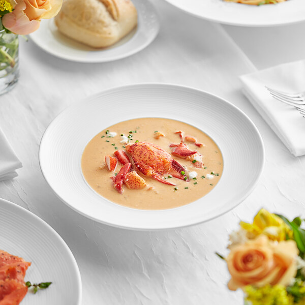 A white Acopa Liana soup bowl with food on it.