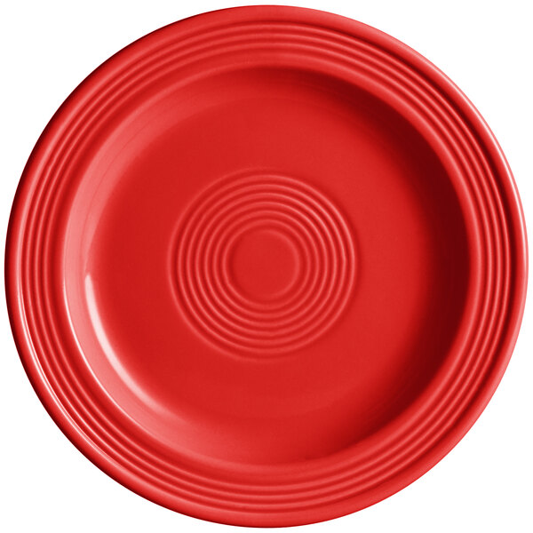 An Acopa Capri passion fruit red stoneware plate with a circular design in the middle.