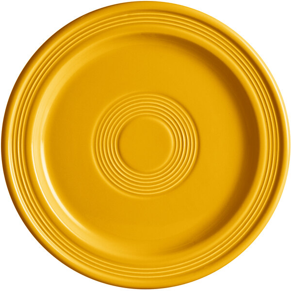 A mango orange Acopa Capri stoneware plate with a circular pattern.
