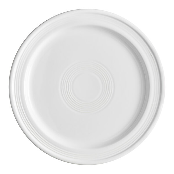 A round, white stoneware plate with a subtle concentric circle design in the center.