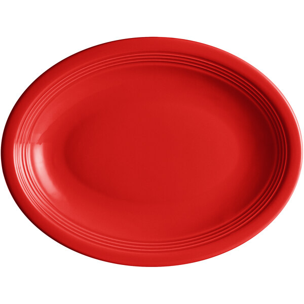 An oval red Acopa Capri stoneware platter with a white rim.