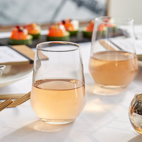 Acopa Radiance tall stemless wine glass filled with wine on a table