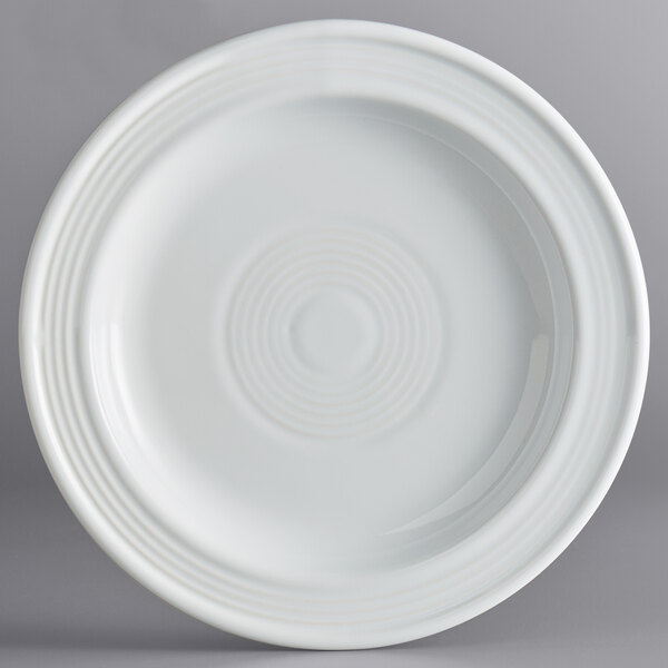 A close up of an Acopa Capri Coconut White stoneware plate with a spiral pattern.