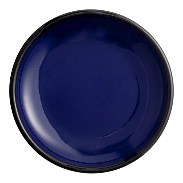 A small, round, blue porcelain coupe plate.