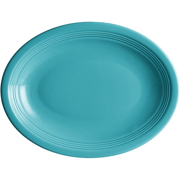 An Acopa Capri Caribbean turquoise oval plate with a rim.