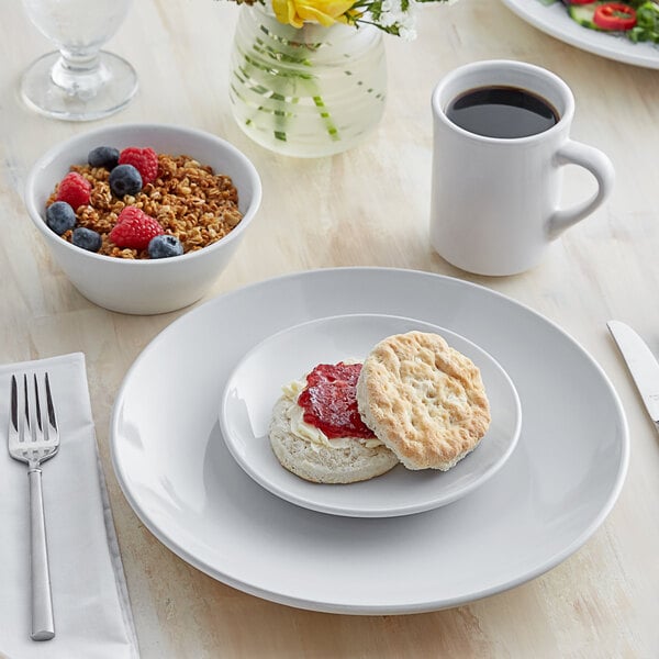 A plate of food with a biscuit on a white Acopa stoneware plate.