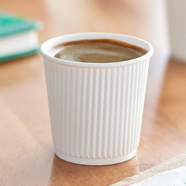 A Choice white paper hot cup filled with coffee on a table.