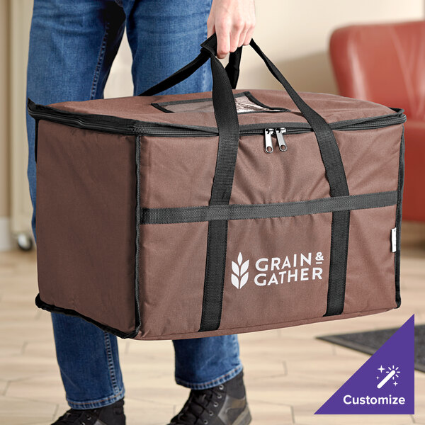 A person carrying a brown Choice insulated food delivery bag with black straps.