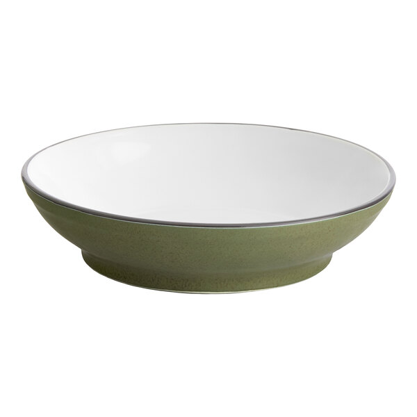 A moss green stoneware pasta bowl with a white rim.
