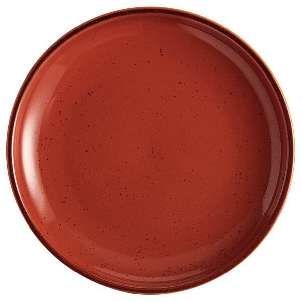 An Acopa Keystone Sedona Orange coupe plate with speckled specks.