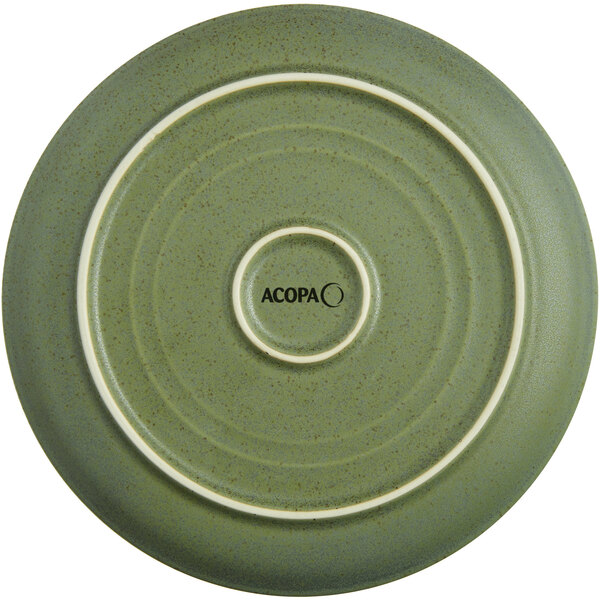 A close-up of an Acopa Moss Green Matte Coupe Stoneware Plate with a circular design in white.