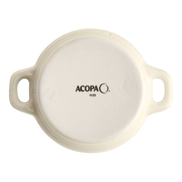 An 8 oz. vanilla bean stoneware mini casserole dish with handles, shown from the bottom with the Acopa brand mark.