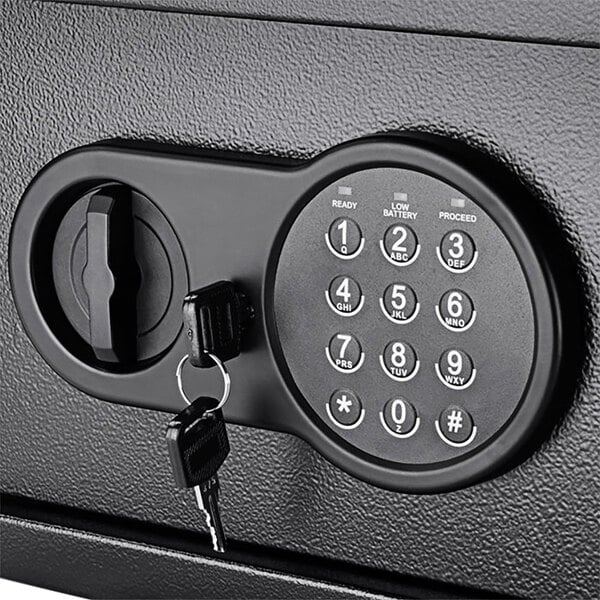 A black Barska compact security safe with a digital keypad and a key lock, with a key in the lock.