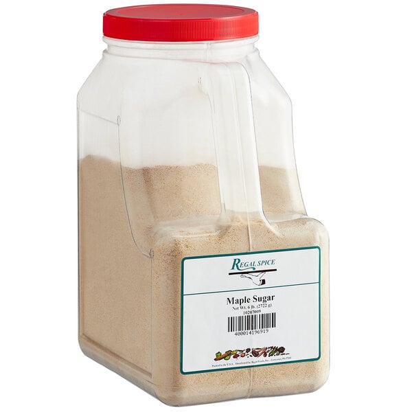 A plastic container of brown powdered Regal Maple Sugar with a red lid.