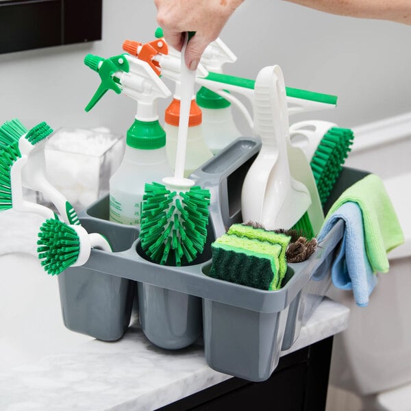A gray maid caddy filled with various cleaning supplies including brushes, spray bottles, sponges, and cloths.