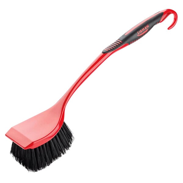 A red Libman long handle scrub brush with black bristles.