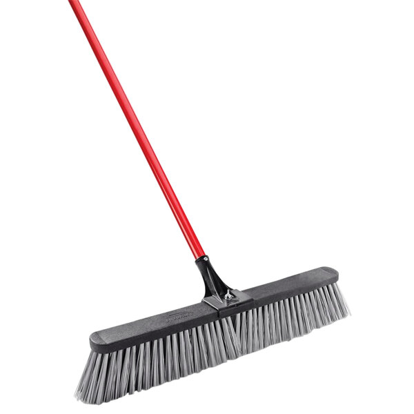 A black and red Libman rough surface push broom with a red handle.