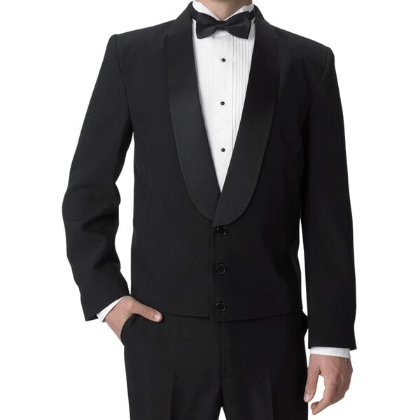 A man wearing a Henry Segal black satin shawl lapel eton jacket over a white shirt and bow tie.