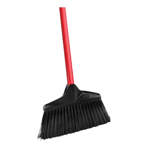 A close-up of a black and red Libman Housekeeper broom with a red handle.
