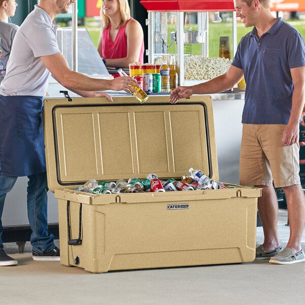 Two men standing next to a CaterGator outdoor cooler.