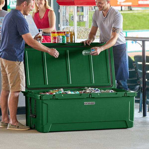 Two men standing next to a CaterGator Hunter Green cooler with the lid open and full of cans.