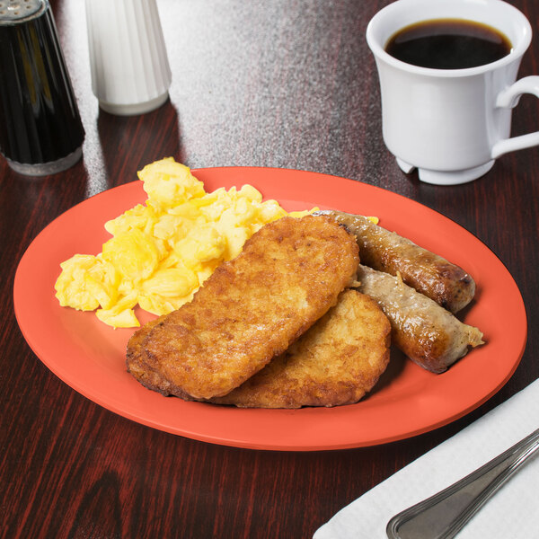 A Rio orange oval melamine platter with food on it and a cup of coffee.