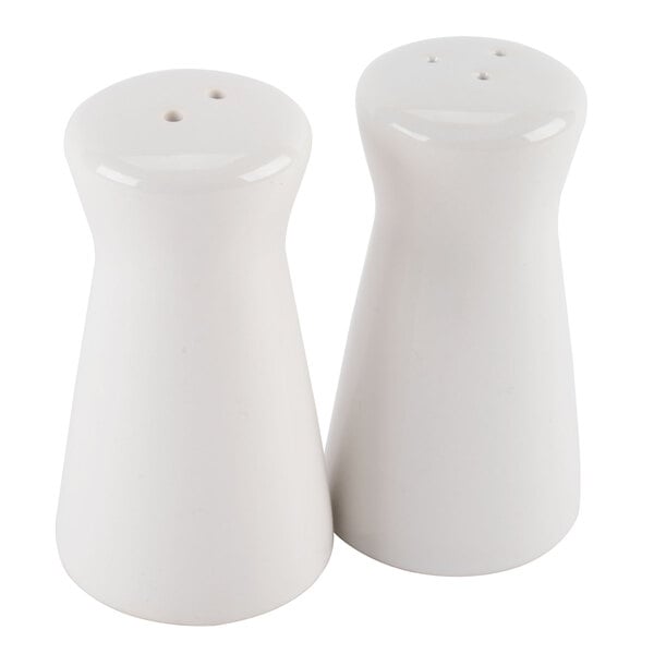 Two white ceramic tower salt and pepper shakers.