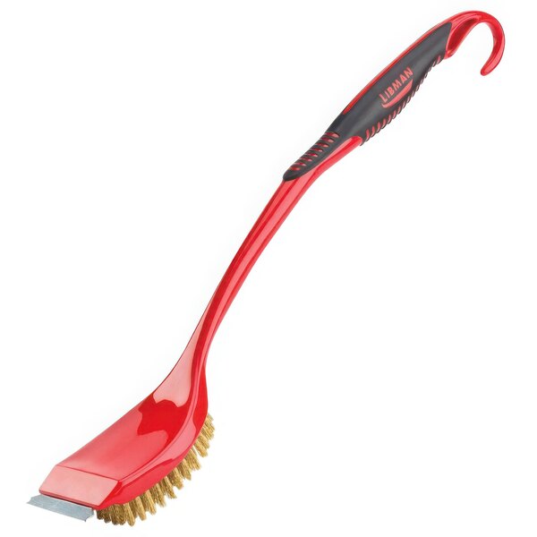 A close-up of a Libman red brush with a black handle.