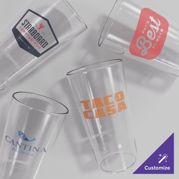 A set of four clear, customizable 20 oz. plastic stackable cooler glasses, each featuring a different printed logo.