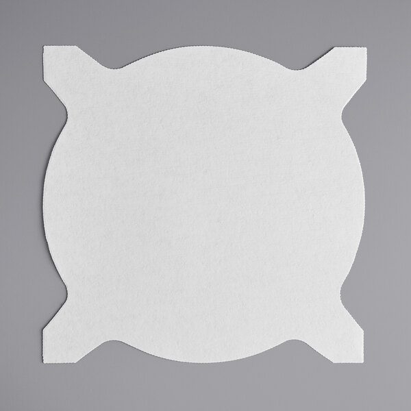 A white circle of filter paper with four tabs.