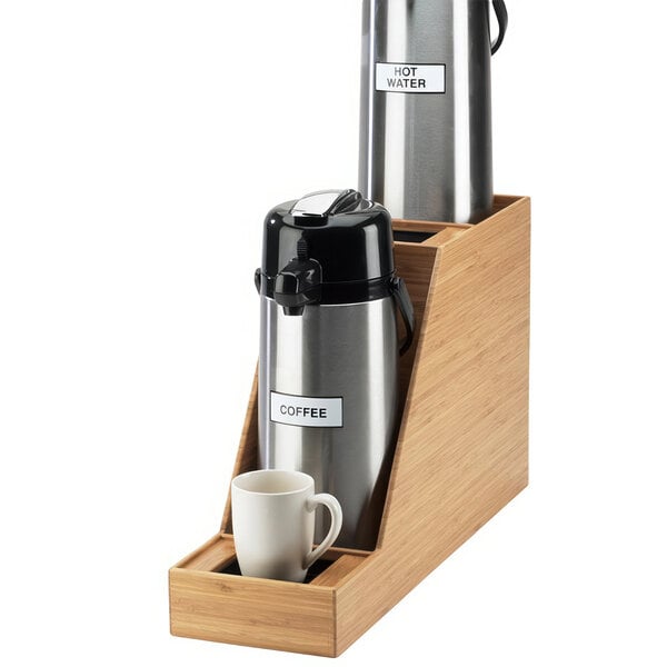 A Cal-Mil bamboo dual airpot display on a wooden table with a white mug.