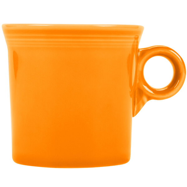 A close-up of a Fiesta Tangerine china mug with a handle.
