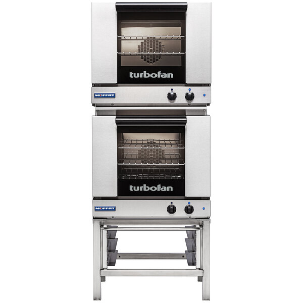 A stainless steel Moffat Turbofan double deck electric convection oven with both doors open.